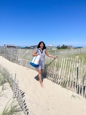 Desiree-Leone-in-Nantucket-wearing-blue-and-white-striped-dress-and-monogram-bag-1152x1536